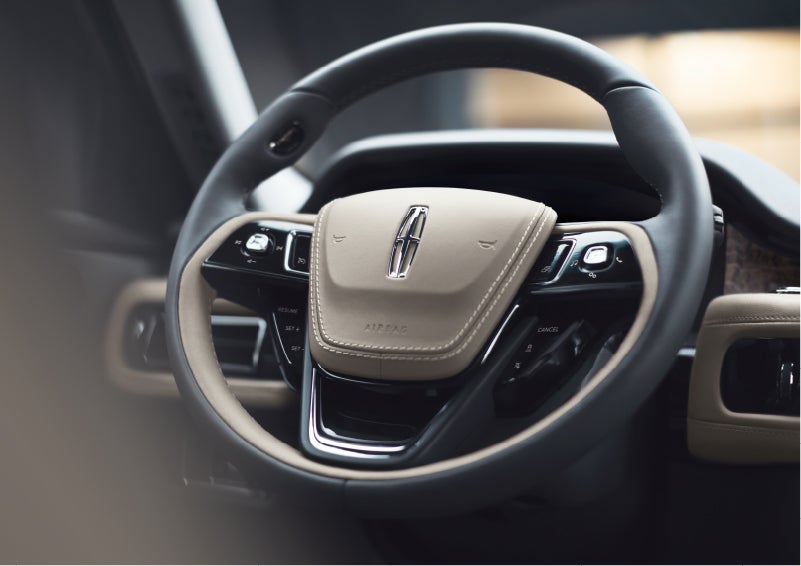 The intuitively placed controls of the steering wheel on a 2023 Lincoln Aviator® SUV | Mike Reichenbach Lincoln in Florence SC