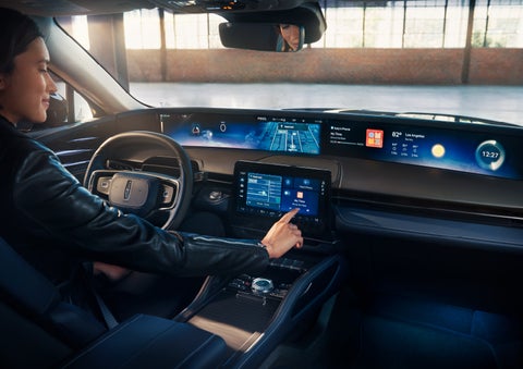The driver of a 2024 Lincoln Nautilus® SUV interacts with the center touchscreen. | Mike Reichenbach Lincoln in Florence SC